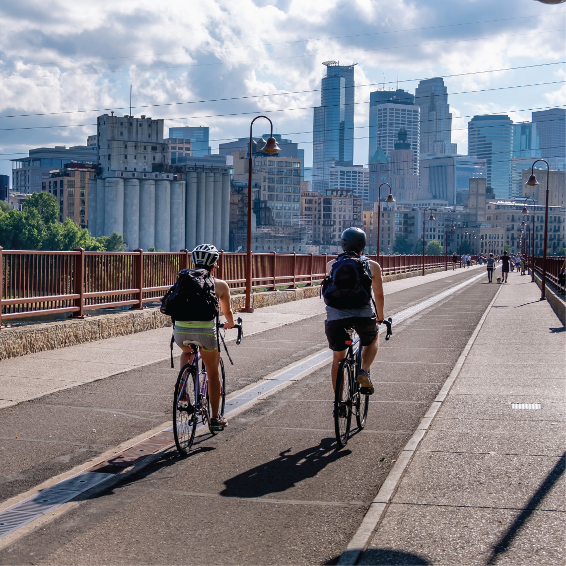 bikers on stone arch bridge