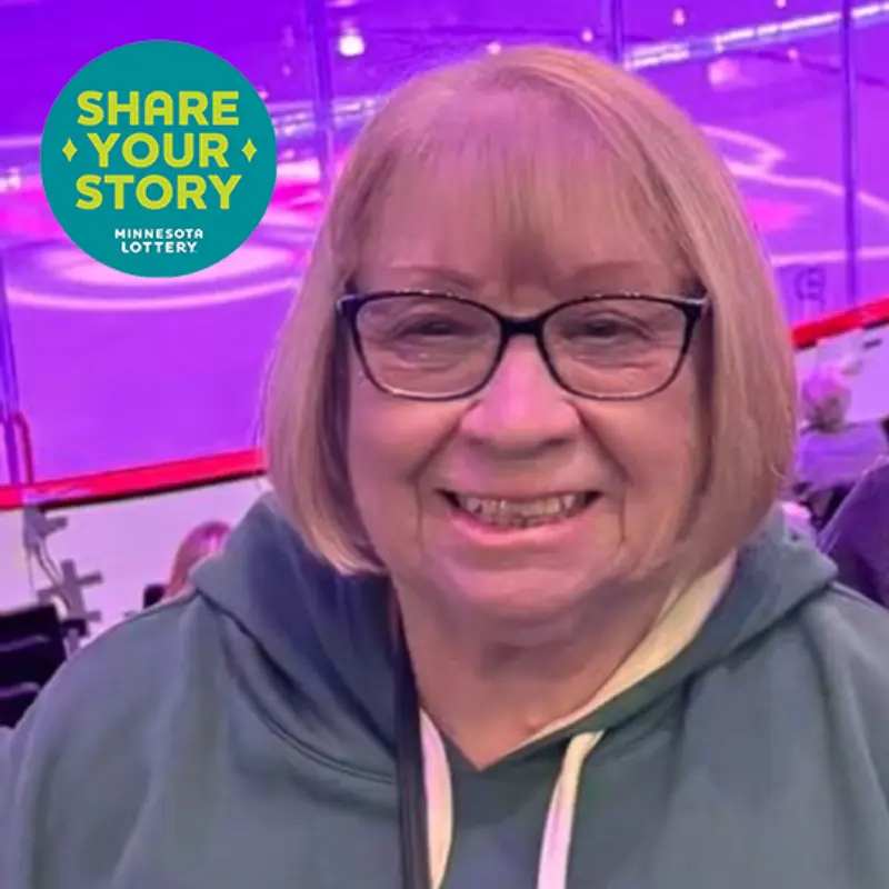 A woman with glasses smiles in front of an ice rink, overlaid with a Minnesota Lottery Share Your Story sticker graphic.