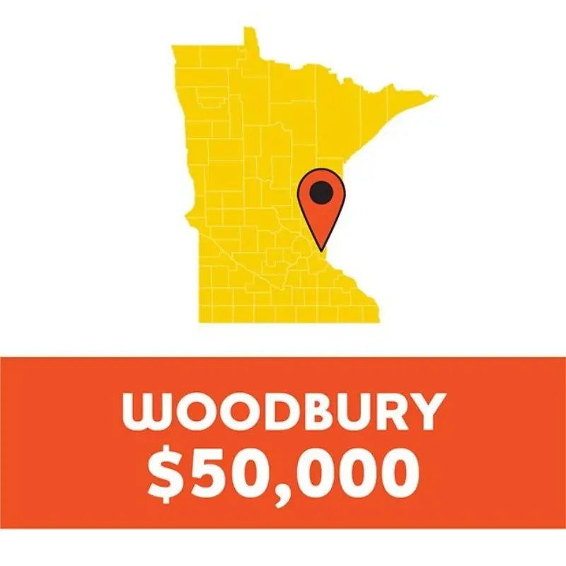 Yellow Minnesota map with red marker at Woodbury. Below, "WOODBURY $50,000" in white on an orange background.