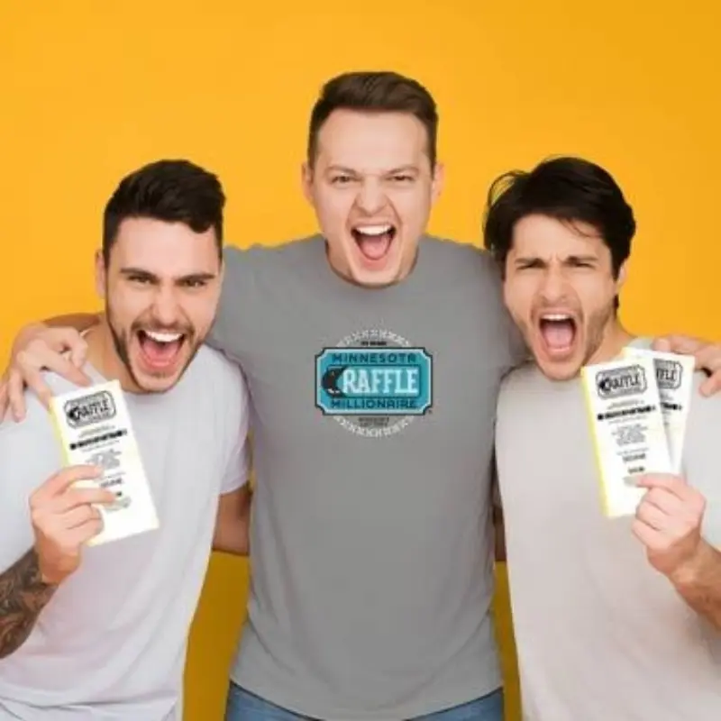 Three men smile and hold up raffle tickets against a yellow background; center wears a gray Minnesota Raffle Millionaire t-shirt.