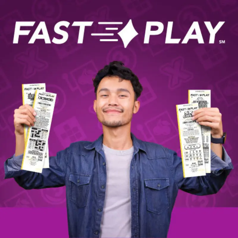 Smiling man in a denim jacket holds lottery tickets in both hands with “FAST PLAY” above him on a purple background.