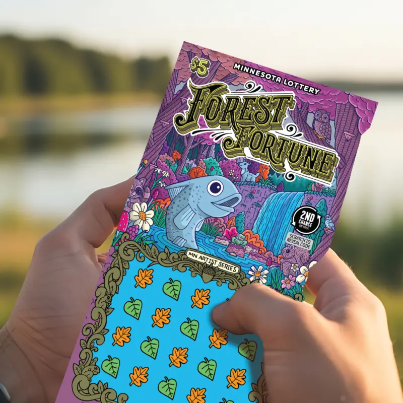 Person scratches a Forest Fortune Minnesota Lottery ticket with cartoon forest animals, outdoors by a lake and trees.