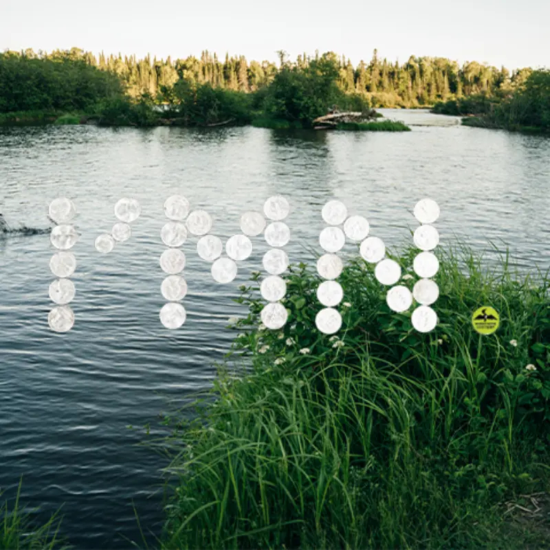 River with green banks and trees, "PMN" spelled in white circles overlays the scene. Small yellow fishing sign at lower right.