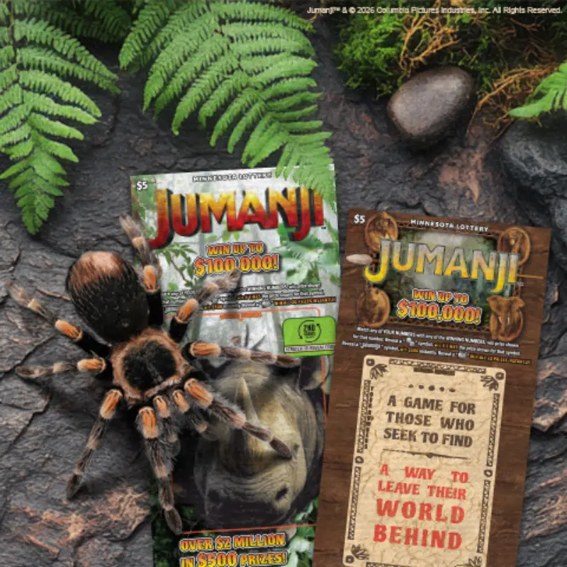 Jumanji-themed Minnesota Lottery ticket on a forest floor with ferns, rocks, and tarantula; win up to $100,000.