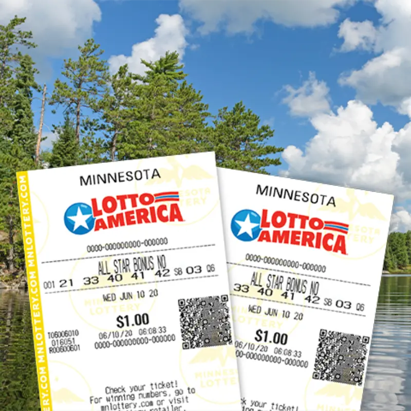 Two Minnesota Lotto America tickets held up by a scenic lake, tall pine trees, and a partly cloudy blue sky in the background.
